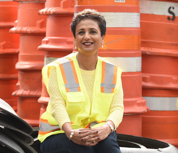 Image of Arti O'Brien in front of traffic barrels.