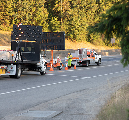 Traffic control trucks diverting traffic on a highway