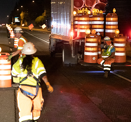 Work crew unloading traffic safety equipment