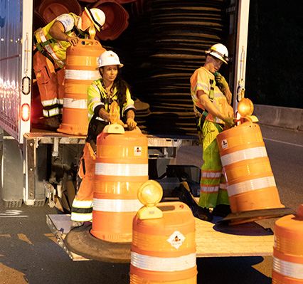 Work crew unloading traffic control equipment