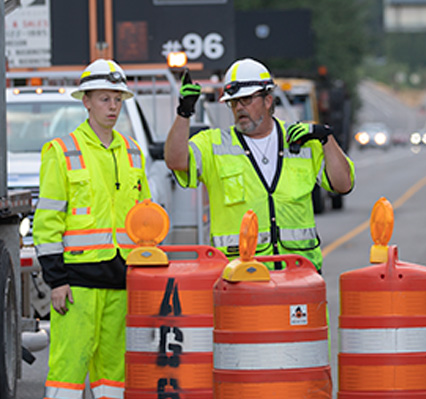 Traffic control workers and traffic barrels