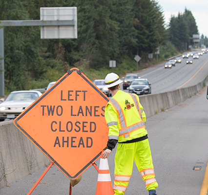 Two left lanes closed ahead traffic sign