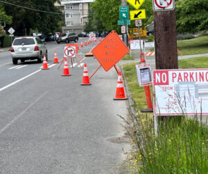 Image of traffic control signs and orange cones.